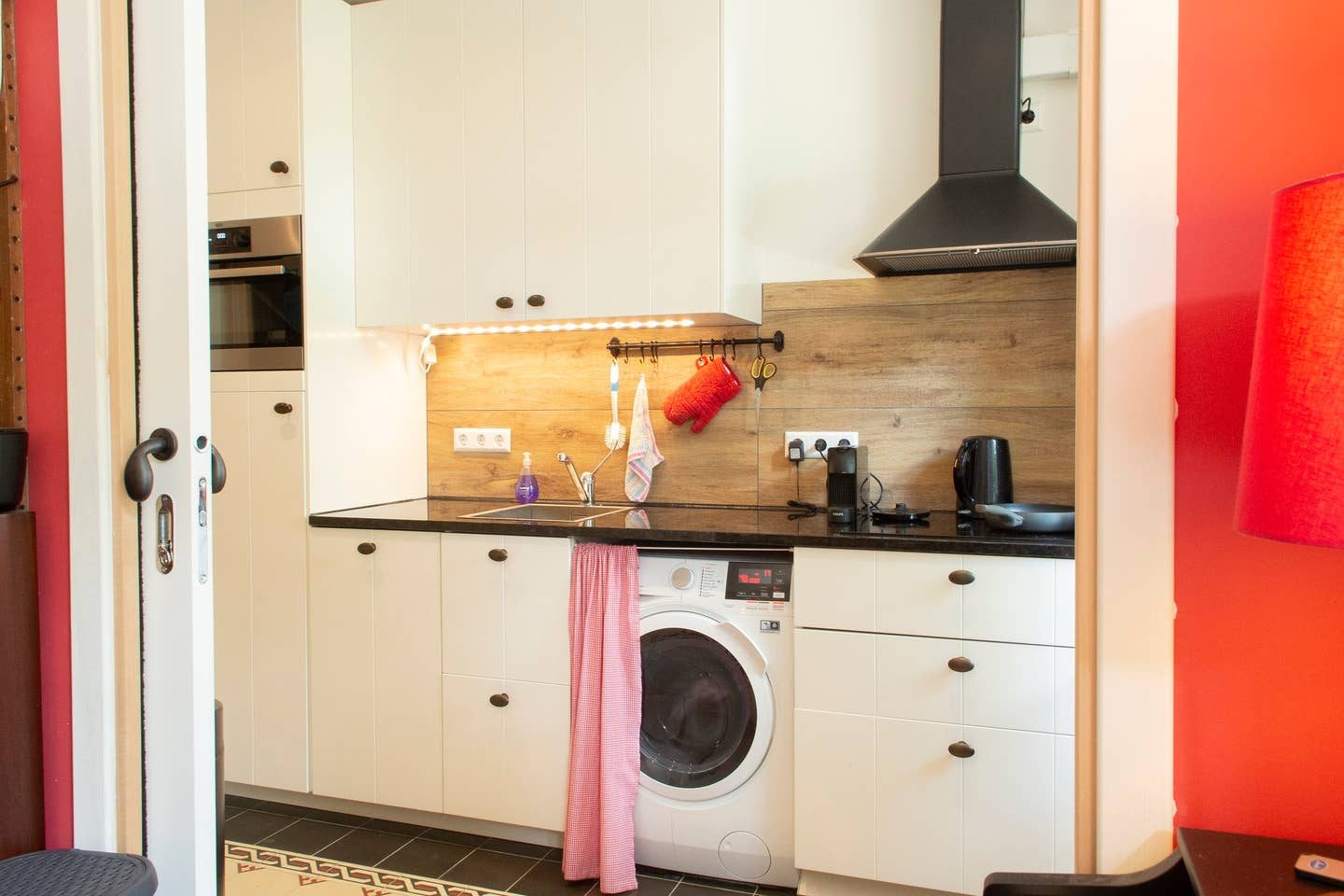 Kitchen with washer-dryer and oven