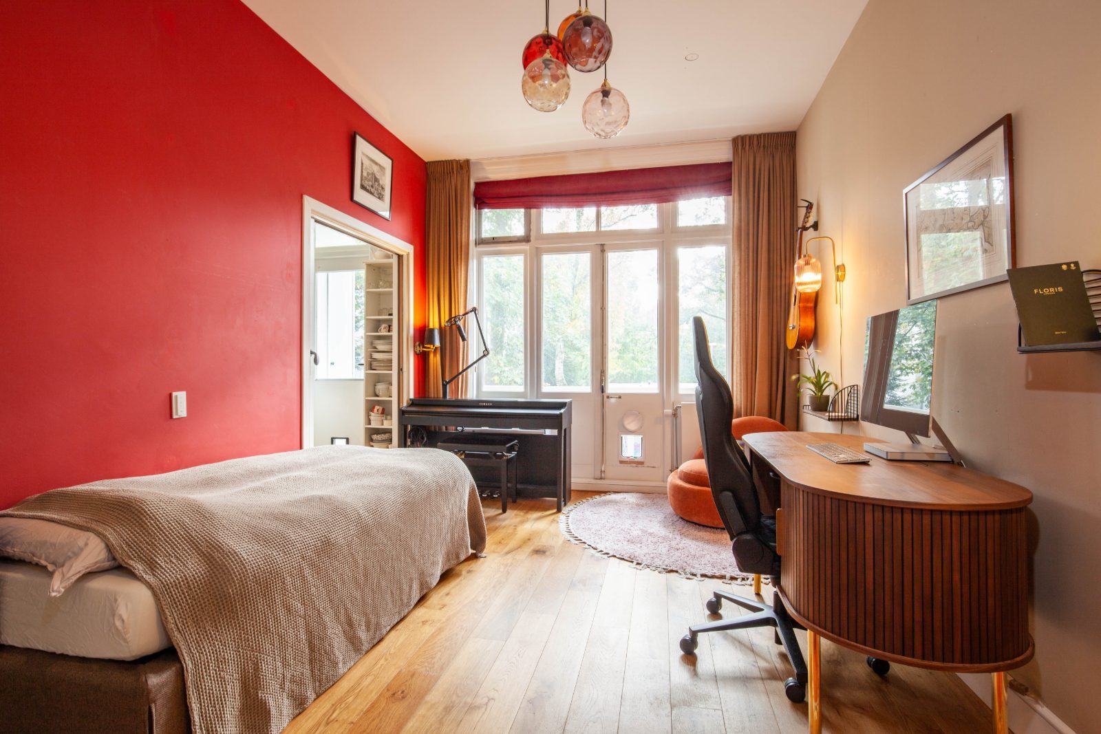 The Red with red accent wall, desk and piano